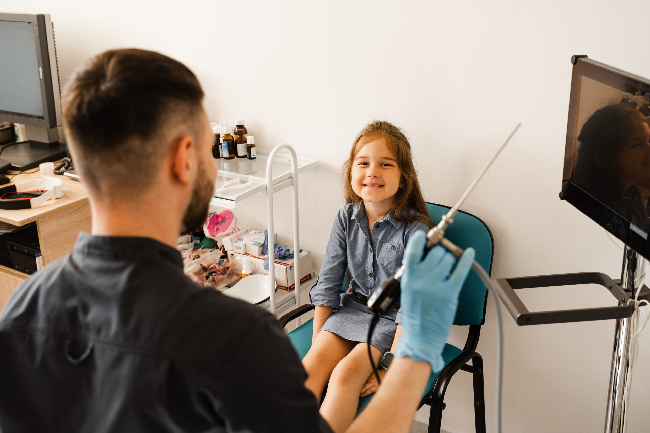 Young child smiling during an early orthodontic evaluation with a pediatric orthodontist in a dental clinic